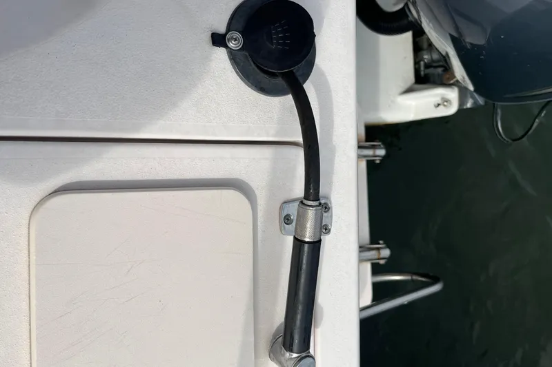 Slide: The Image of Close-up of a 2004 Grady-White Gulfstream 232 boat's fuel line and deck. - 22