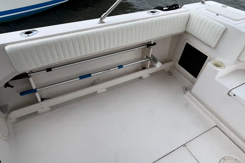 Slide: The Image of 2004 Grady-White Gulfstream 232 boat interior with white seating and storage compartments. - 33