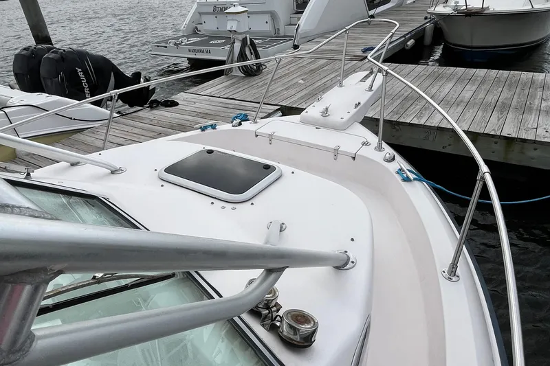 Slide: The Image of 2004 Grady-White Gulfstream 232 boat docked, showcasing deck and railing details. - 34