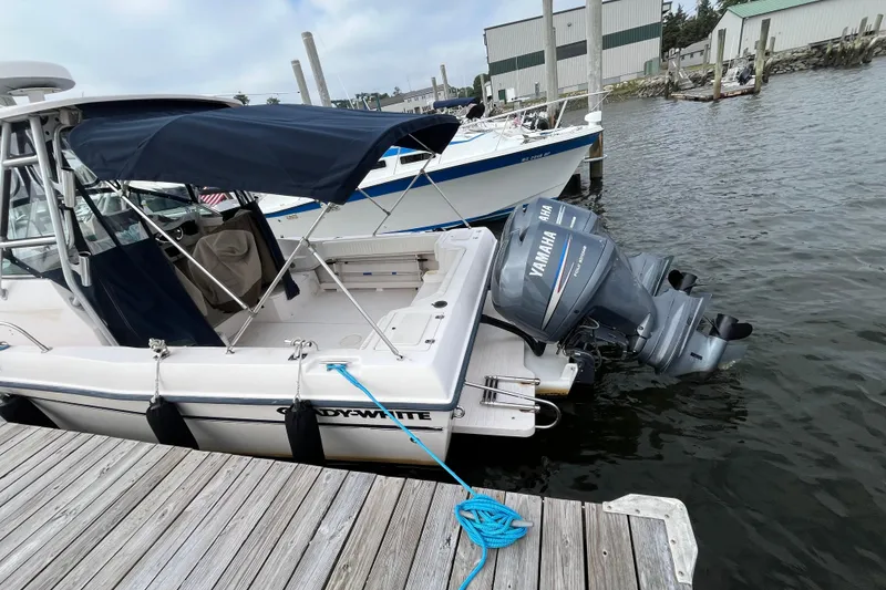 Slide: The Image of 2004 Grady-White Gulfstream 232 boat docked with Yamaha outboard motor. - 5