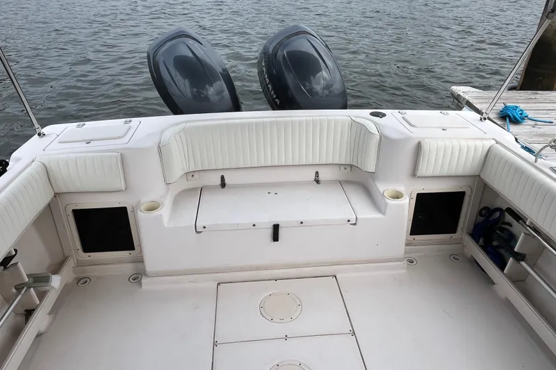 Slide: The Image of 2004 Grady-White Gulfstream 232 boat interior with twin engines and white seating. - 6