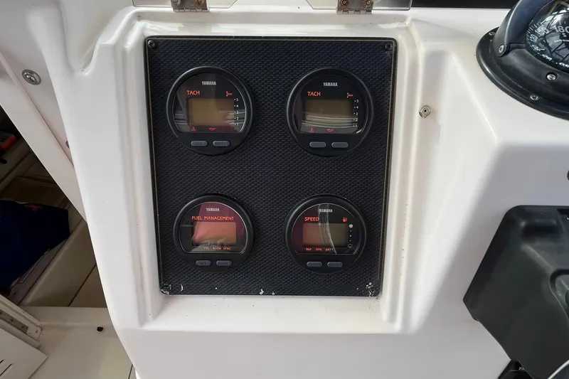 Slide: The Image of Yamaha gauges on 2004 Grady-White Gulfstream 232 boat dashboard. - 9