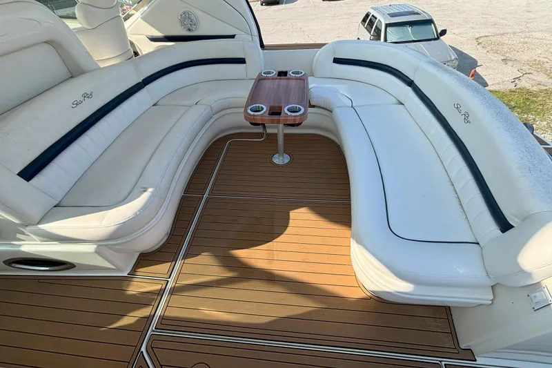 Slide: The Image of Luxurious seating area on 2005 Sea Ray 420 Sundancer yacht with wooden deck and table. - 13