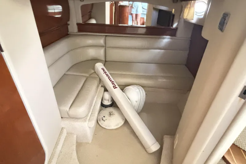 Slide: The Image of 2005 Sea Ray 420 Sundancer interior with beige seating and Raymarine equipment. - 15