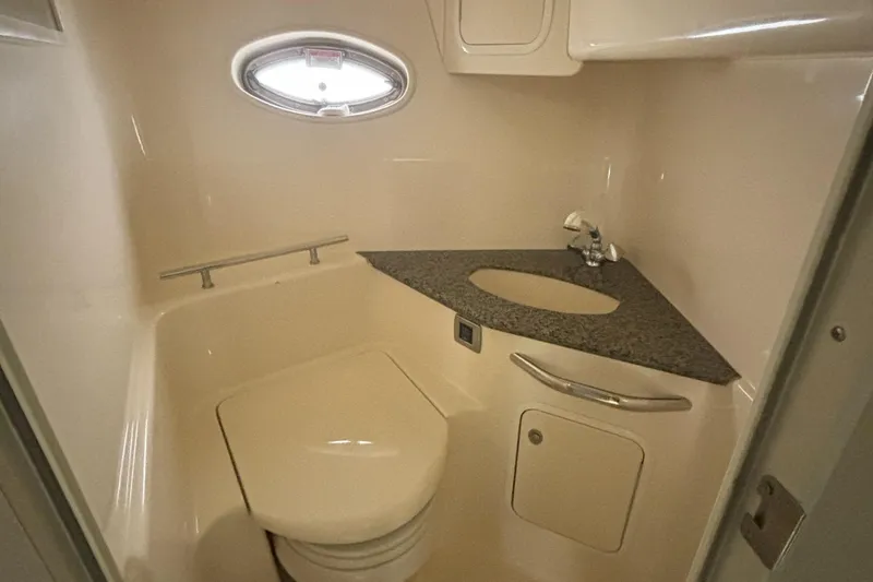 Slide: The Image of 2005 Sea Ray 420 Sundancer bathroom with compact toilet and sleek countertop design. - 16