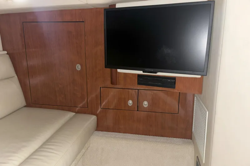 Slide: The Image of Interior of 2005 Sea Ray 420 Sundancer with TV and wooden cabinetry. - 17