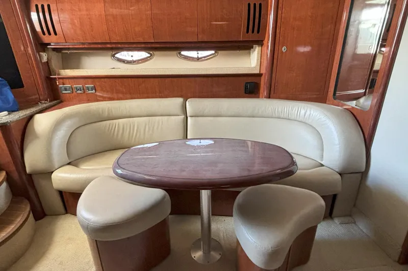 Slide: The Image of Luxurious 2005 Sea Ray 420 Sundancer yacht interior with elegant seating and wooden table. - 19