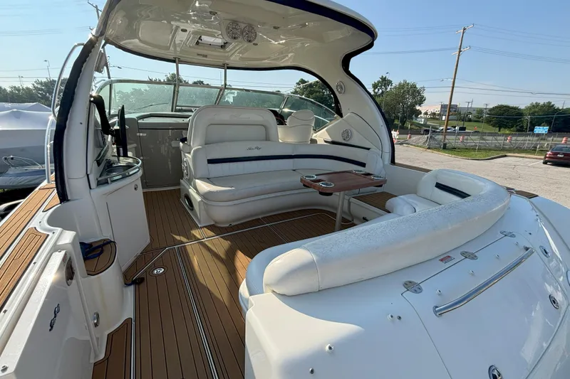 Slide: The Image of 2005 Sea Ray 420 Sundancer yacht interior with white seating and wooden deck. - 2