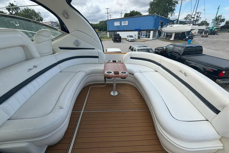 Slide: The Image of 2005 Sea Ray 420 Sundancer yacht interior with white seating and wooden table. - 23