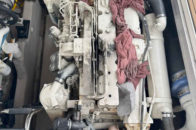 Slide: The Image of Engine compartment of a 2005 Sea Ray 420 Sundancer with visible components and hoses. - 28