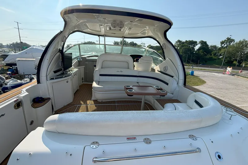 Slide: The Image of 2005 Sea Ray 420 Sundancer yacht interior with seating and table, docked outdoors. - 3