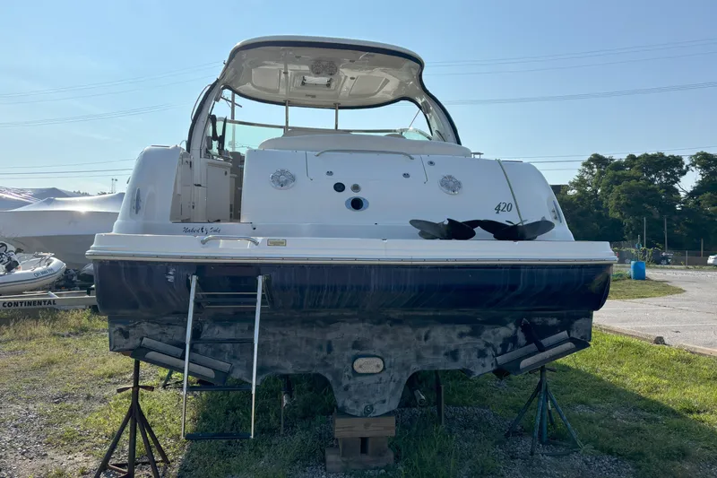 Slide: The Image of 2005 Sea Ray 420 Sundancer yacht on land, rear view with ladder and open cockpit. - 5