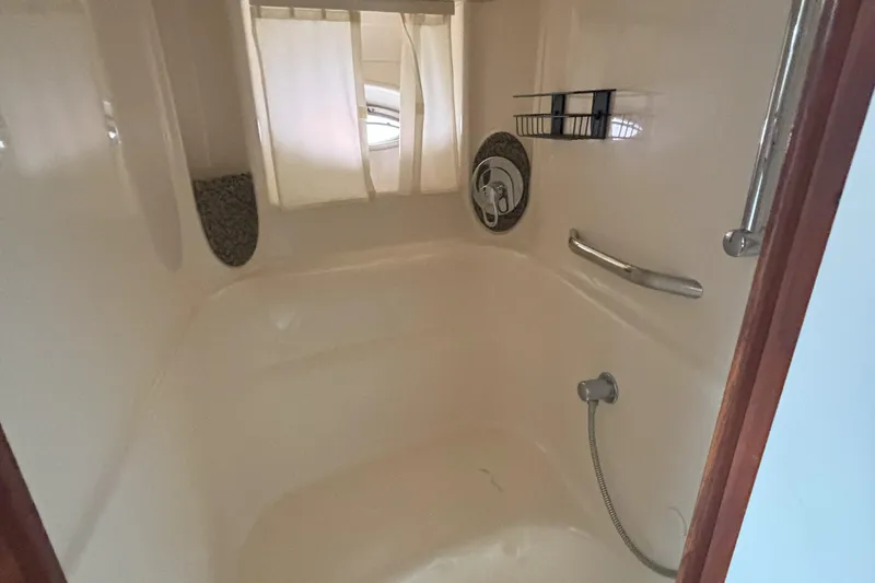 Slide: The Image of Shower area inside 2005 Sea Ray 420 Sundancer yacht, featuring curtain and chrome fixtures. - 6