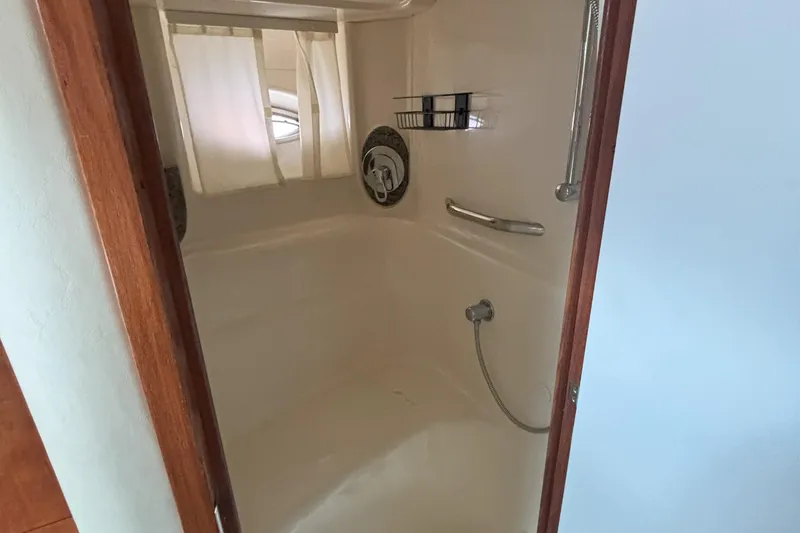 Slide: The Image of Shower area inside 2005 Sea Ray 420 Sundancer yacht, featuring curtain and handheld showerhead. - 7