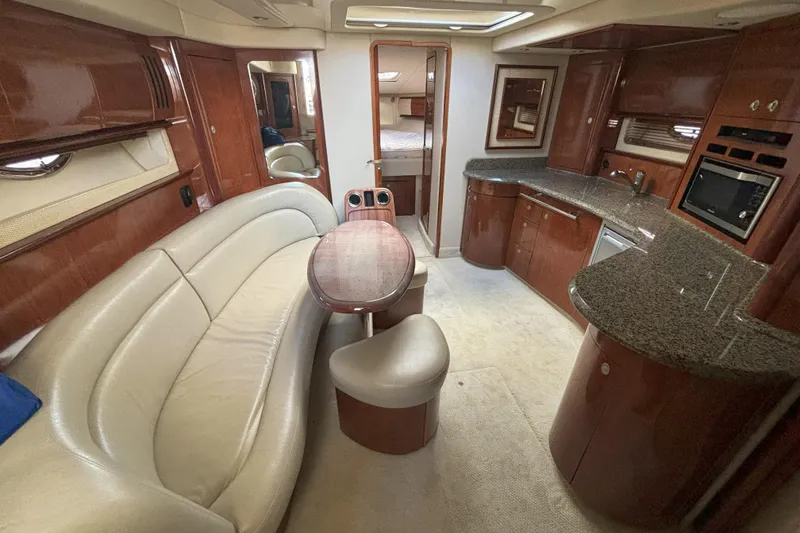 Slide: The Image of Luxurious 2005 Sea Ray 420 Sundancer yacht interior with elegant seating and modern kitchen amenities. - 9