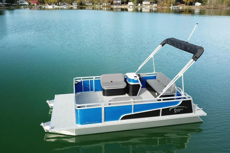 Slide: The Image of 2026 Paddle King Lo Pro Cruiser pontoon boat on a serene lake. - 3