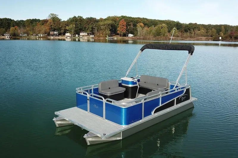 Slide: The Image of 2026 Paddle King Lo Pro Cruiser pontoon boat on a serene lake. - 4