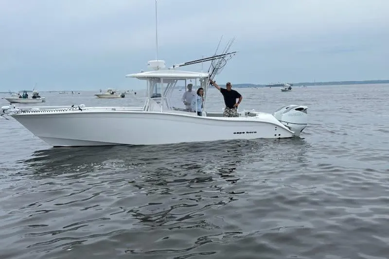 Slide: The Image of 2023 Cape Horn 32 XS boat on calm water with two people onboard. - 1