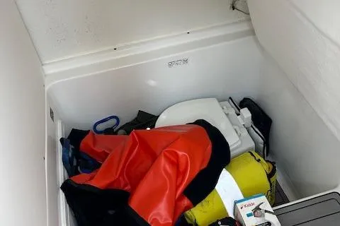 Slide: The Image of Storage compartment in 2023 Cape Horn 32 XS boat with safety gear and equipment. - 14