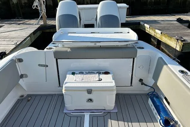 Slide: The Image of 2023 Cape Horn 32 XS boat interior with seating, cooler, and deck details. - 6
