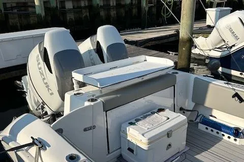 Slide: The Image of 2023 Cape Horn 32 XS boat with dual Suzuki engines docked at marina. - 9