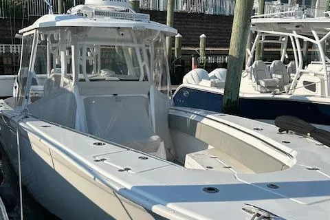 Slide: The Image of 2023 Cape Horn 32 XS boat docked, featuring sleek design and spacious deck. - 10