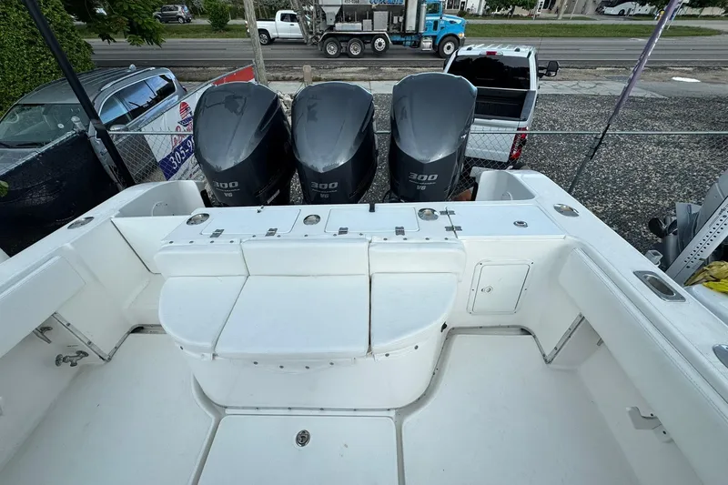 Slide: The Image of 2004 Fountain 34 CC boat with triple 300 HP engines, parked in a lot. - 10