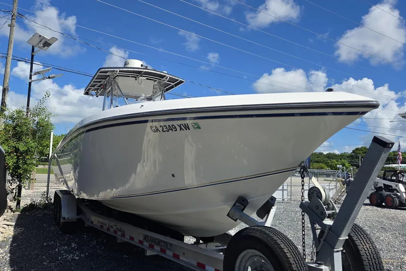 Slide: The Image of 2004 Fountain 34 CC boat on trailer under blue sky. - 2