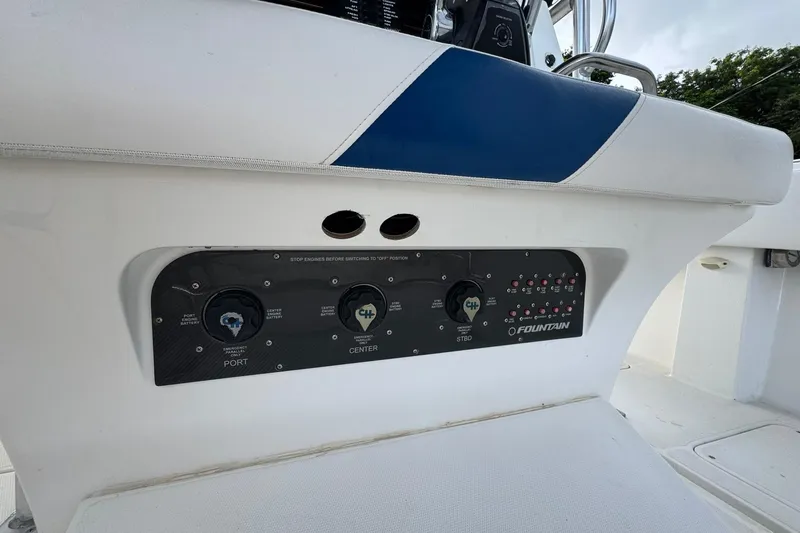 Slide: The Image of Control panel of a 2004 Fountain 34 CC boat with switches and labels. - 4