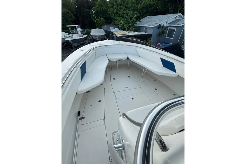 Slide: The Image of 2004 Fountain 34 CC boat interior with white seating and spacious deck. - 5