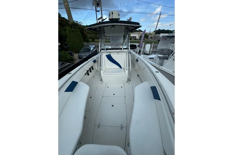 Slide: The Image of 2004 Fountain 34 CC boat interior with white seating and blue accents. - 6