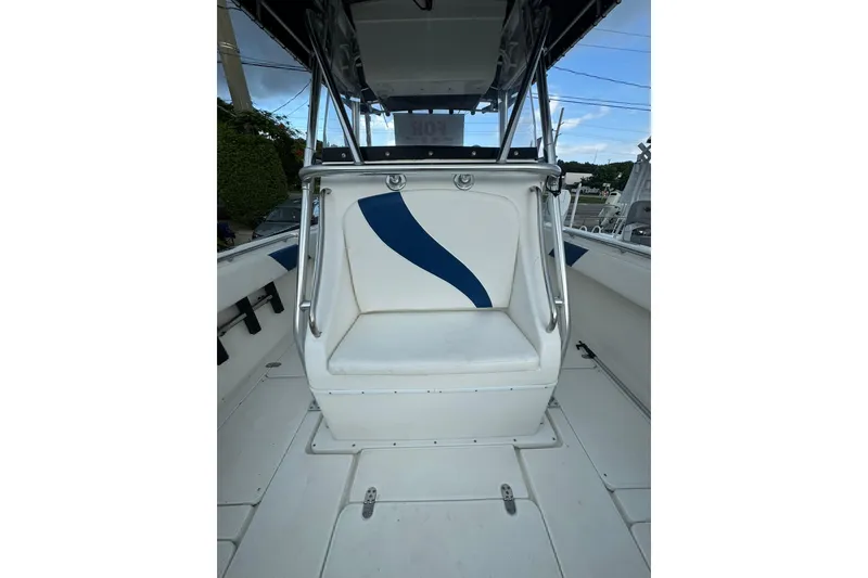 Slide: The Image of 2004 Fountain 34 CC boat interior with white seating and blue accent. - 7
