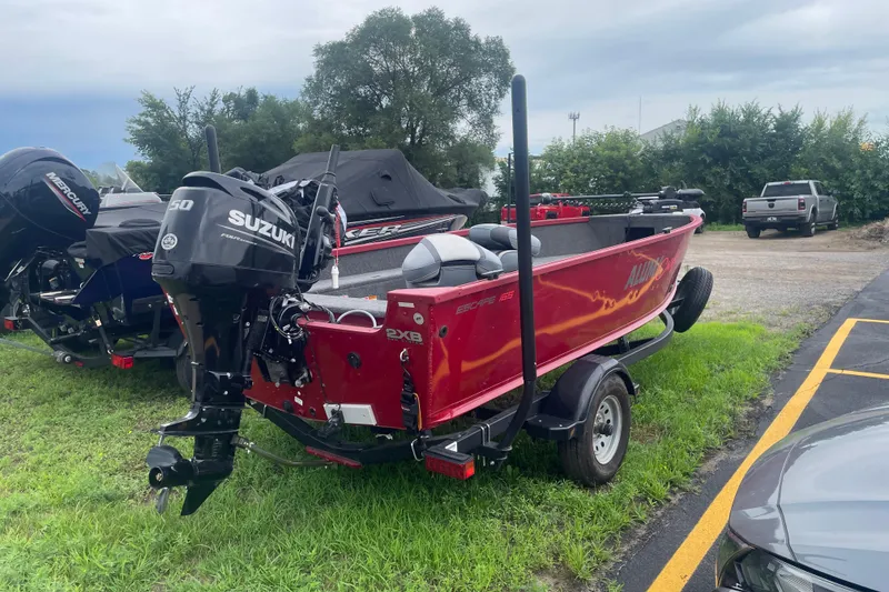 Slide: The Image of 2024 Alumacraft Escape 165 Tiller boat with Suzuki outboard motor on trailer. - 3