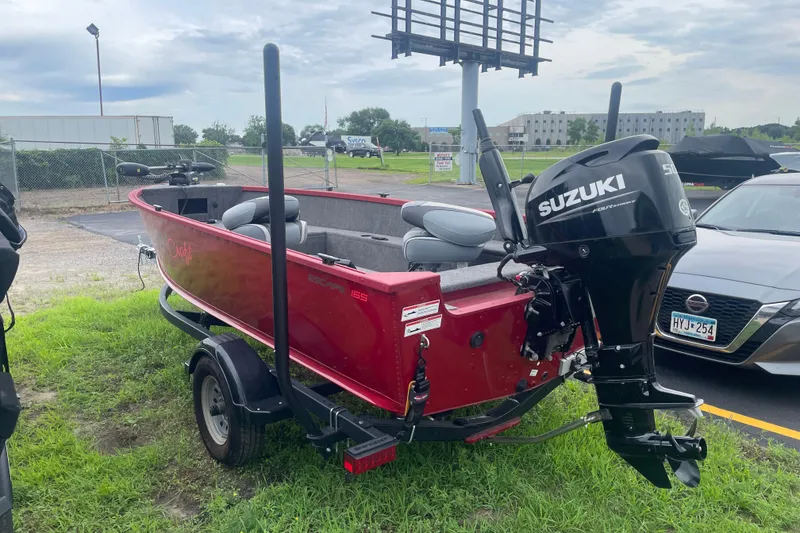 Slide: The Image of 2024 Alumacraft Escape 165 Tiller boat with Suzuki motor on trailer, parked outdoors. - 4