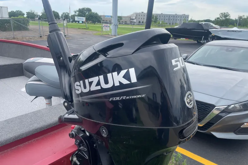 Slide: The Image of 2024 Alumacraft Escape 165 Tiller with Suzuki 50HP outboard motor in parking lot. - 5