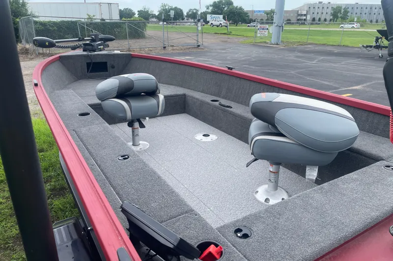 Slide: The Image of 2024 Alumacraft Escape 165 Tiller boat interior with gray seating and red trim. - 6