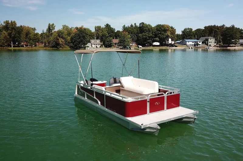 Slide: The Image of 2026 Paddle King Lo Pro Cruiser XL pontoon boat on a serene lake. - 3