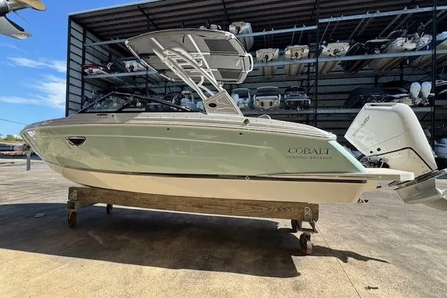 The Image of 2026 Cobalt R6 Outboard boat in storage, surrounded by other boats. - 0