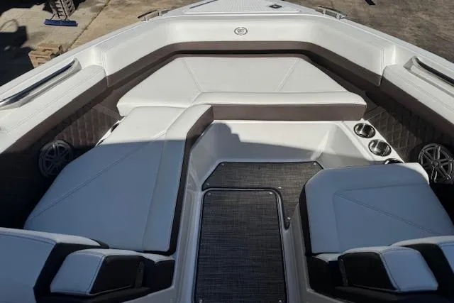 Slide: The Image of 2026 Cobalt R6 Outboard boat interior with white cushioned seating and cup holders. - 11