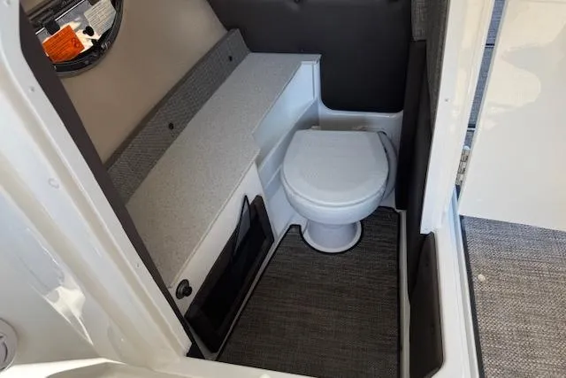 Slide: The Image of 2026 Cobalt R6 Outboard boat interior with compact bathroom and toilet. - 13