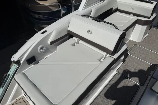 Slide: The Image of 2026 Cobalt R6 Outboard boat interior with white cushioned seating. - 22
