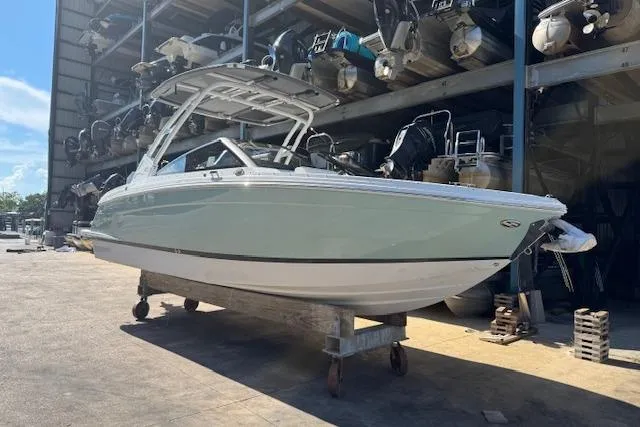 Slide: The Image of 2026 Cobalt R6 Outboard boat in storage, side view, under a metal shelter. - 4