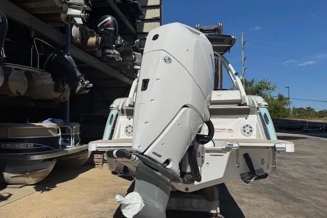 Slide: The Image of 2026 Cobalt R6 Outboard boat with powerful engine, docked in a marina under clear skies. - 8