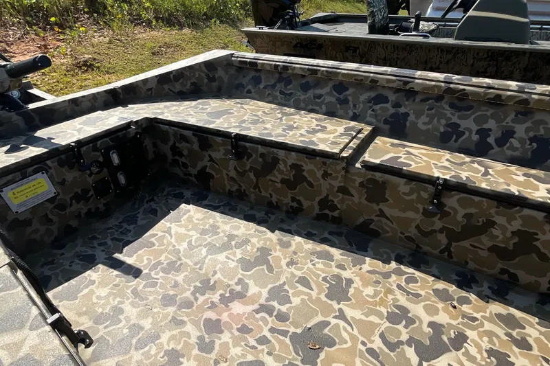 Slide: The Image of 2026 Excel 1651 Viper F4 boat interior with camouflage design, featuring storage compartments. - 5