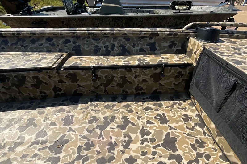 Slide: The Image of Camouflage interior of 2026 Excel 1651 Viper F4 boat, featuring seating and storage. - 6