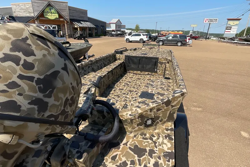 Slide: The Image of 2026 Excel 1651 Viper F4 boat with camouflage design in a parking lot. - 8