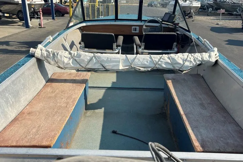 Slide: The Image of 1984 Hewescraft River Runner 16 boat interior with seating and steering console. - 4