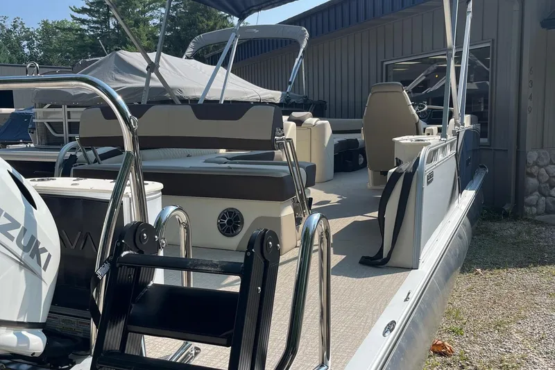 Slide: The Image of 2026 Avalon 23 LSZ Cruise Rear Bench pontoon boat with Suzuki engine, docked outdoors. - 8