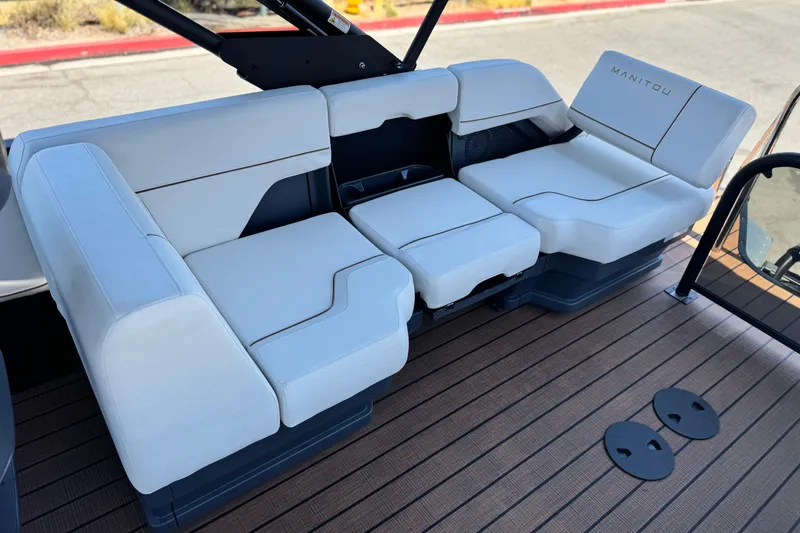 Slide: The Image of Luxurious seating on 2025 Manitou EXPLORE 26 boat, featuring sleek white upholstery. - 15