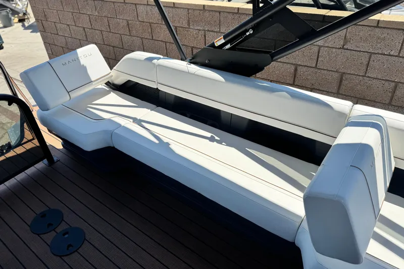 Slide: The Image of Luxurious seating on 2025 Manitou EXPLORE 26 boat, featuring sleek white upholstery. - 18